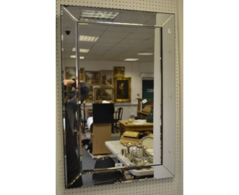 A contemporary cushion framed mirror
