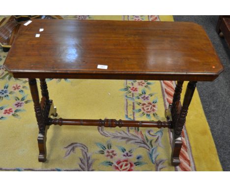 An Aesthetic Movement mahogany centre table, moulded rectangular top, canted angles, four turned end supports, spindled end, 