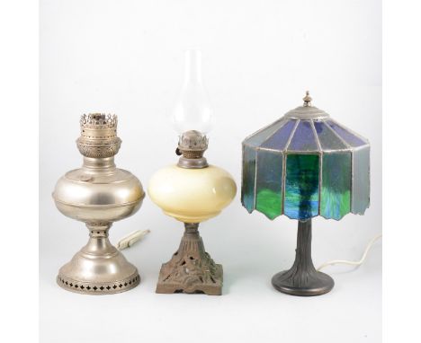 Various lamp bases, oil lamps, and additional glass shades and chimneys.
