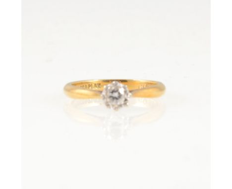 A diamond solitaire ring, the brilliant cut stone illusion set in a yellow and white metal mount marked 18ct &amp; Plat, appr