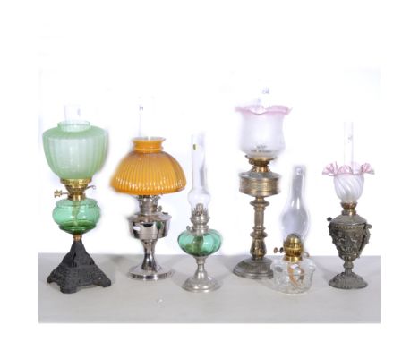 Six oil lamps; including Hinks &amp; Son with brass column, chimney and pink shade 66cm, Aladdin Industries Ltd no.21 chromed