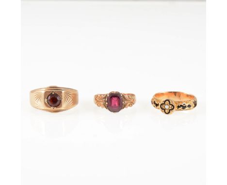 Three vintage gold rings, a gentleman's 9 carat yellow gold signet ring set with a round brilliant cut garnet, gross weight a