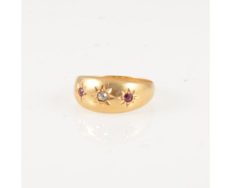 A ruby and diamond dress ring, the old cut diamond and two rubies star gypsy set in an 18 carat yellow gold tapered band, hal