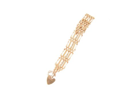 A 9 carat yellow gold five bar gate link bracelet, alternating plain and twisted links, 15mm wide, fitted with a padlock fast