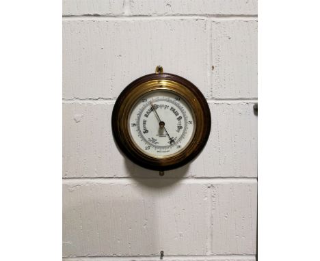 A brass drum cased ship's barometer, the dial signed John Barker &amp; Co. Ltd, Kensington, oak mounted, diameter overall 27c