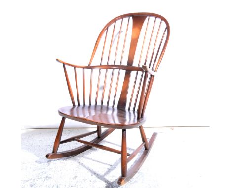 Ercol stained beech and elm rocking chair, stick-back, narrow arms, width 62cm; and a stripped wood kitchen chair, with a spi