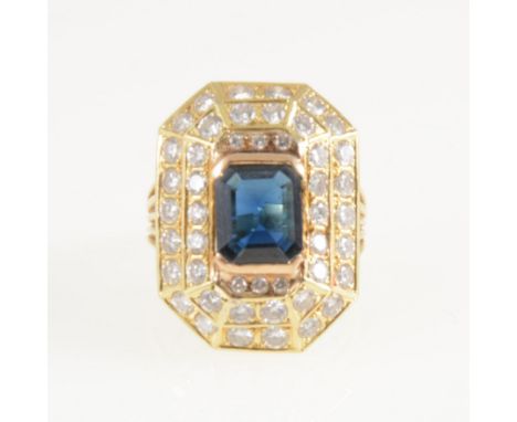 A large sapphire and diamond rectangular cluster ring, a rectangular step cut sapphire 9.7mm x 7.8mm x 3.2mm, semi rubbed ove