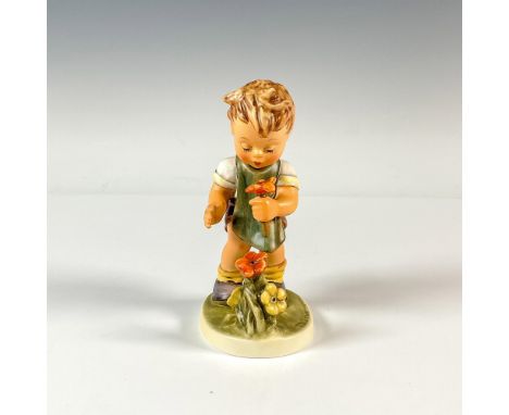 A sweet figure of a boy smelling a flower he just picked. Hummel backstamp. M.I. Hummel impressed. Issued: 1990Dimensions: 3.