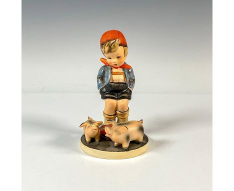 A figure of a boy wearing big red slippers and a blue flannel coat standing next to his two pigs. Goebel backstamp. Issued: 1
