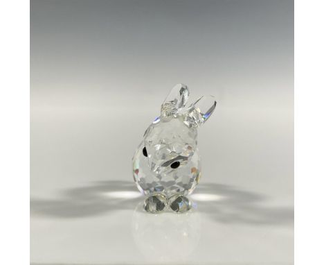 A clear faceted figure of a resting bunny with black eyes and ears pointing back. Part of the In a Summer Meadow series. Swar