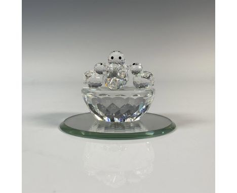 A clear faceted figure depicting a nest with a mother bird and her baby chicks. They have frosted beaks and black eyes. Part 