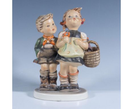 Hand-painted porcelain figurine depicting a young Bavarian boy and girl, most likely siblings, setting off for a day at the m