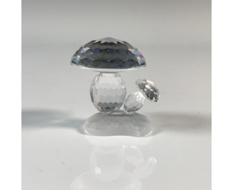A large and small shroom with clear cut crystal bodies growing out of a patch of frosted ground. This item has its original b