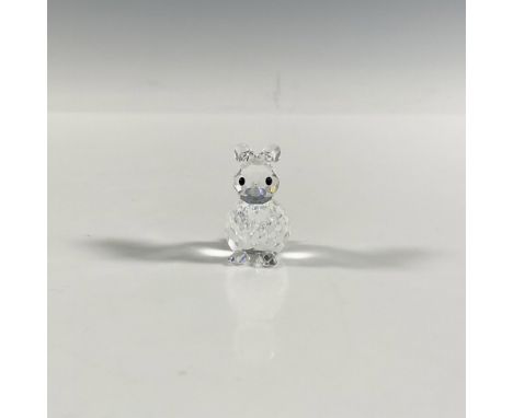 A clear faceted figure of a sitting rabbit with black eyes and ears pointed back. Swarovski marking. This item has its origin