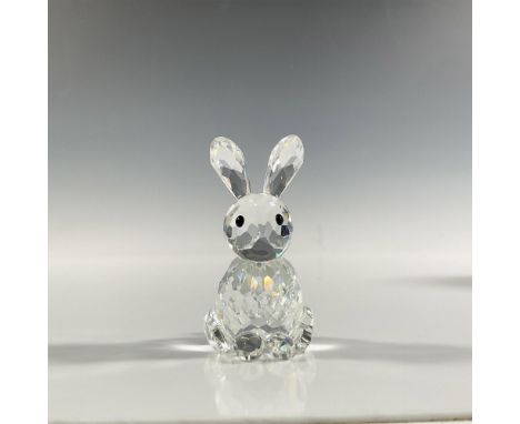 A clear faceted figure of a sitting bunny with ears pointing up and black eyes. Part of the In A Summer Meadow series. Swarov