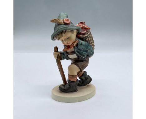 Charming hand painted porcelain of an adorable young flower vendor walking with his walking stick. Backstamped with Goebel W.