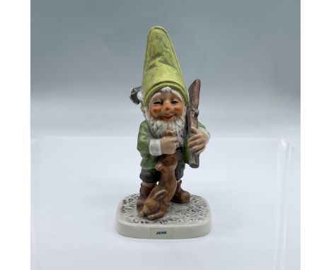An adorable hand painted porcelain of an elated Gnome holding his prey and rifle after a hunt . Backstamped with bee V by Goe