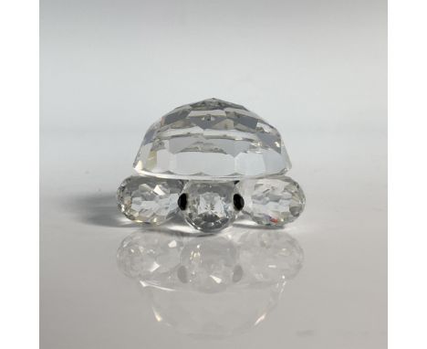 The resting reptile has a clear cut crystal body with black eyes. This item has its original box which measures 2.5"H x 3.25"