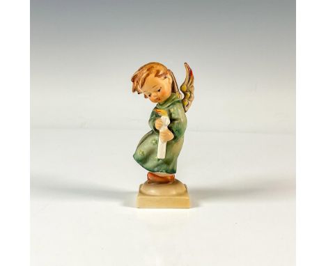 A figure of a sweet angel holding a candle and wearing a green dress decorated with stars. M.I. Hummel impressed. Goebel back