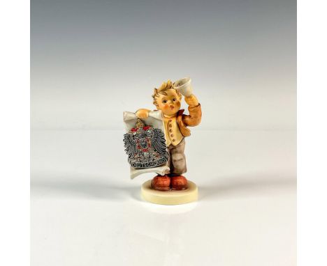 A figure of a boy holding a bell and scroll with a metal Deutschland medallion. M.I. Hummel impressed. Signed at the bottom. 