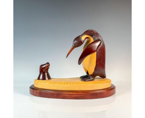 Natural wood sculpture of a penguin encountering a seal. Multiple wood varieties were used to create this simple but beautifu
