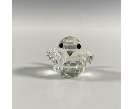 A clear faceted figure of a round bird with black eyes and a metal beak. Part of the Mini Zoo collection. Swarovski marking. 