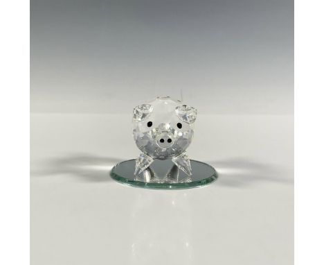 A clear faceted figure of a hog with black eyes, black crystals on the snout and a smooth curly tail. Swarovski marking. Incl