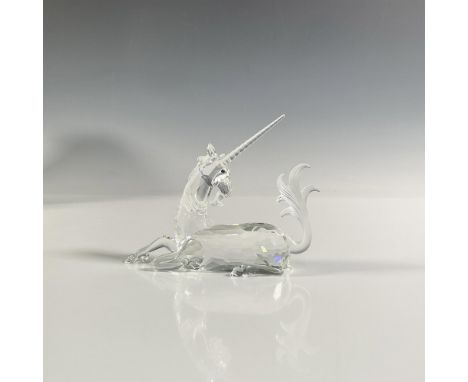 A clear faceted figure of a horse-like mythical creature lying down with black eyes and frosted hair, mane and horn. 1996 Swa