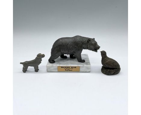 A collection of small figurines crafted from various metals such as a pewter. Spaniel, bronze quail, and a Philip R. Goodwin 