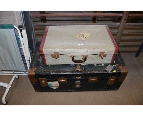 A metal bound trunk and a suitcase