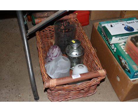 A basket containing candle lanterns and light shades 