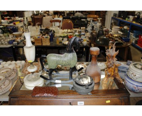 A WWII era compass AF, a wooden and metal rocking horse ornament and root carving, an onyx table lamp etc.