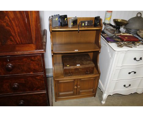 An Ercol graduated bookcase with cupboard base