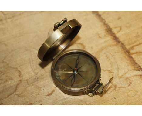 A brass compass (65)