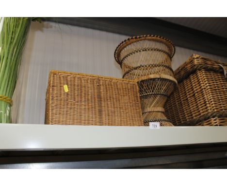 A wicker pedestal basket and a wicker hamper type basket