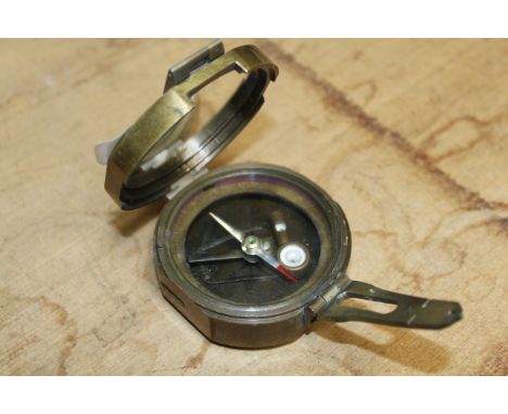 A brass cased compass (66)