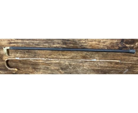 Shephard's crook together with a walking stick with Eagle head 