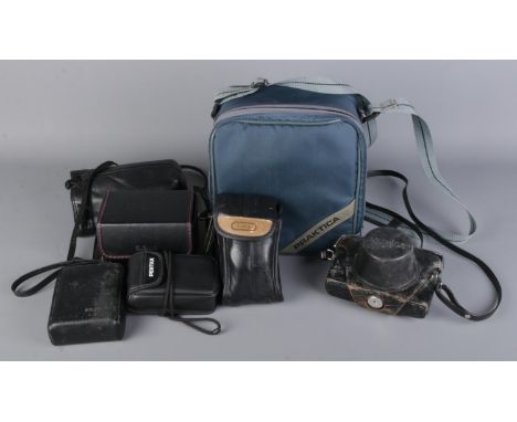 A box of vintage cameras and equipment, including Practica BCA Electronic camera set with three lens (Prakticar 1:1.8 f50mm, 