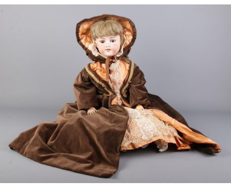 A German Armand Marseille bisque headed dolls in period dress. Numbered 390 to back of neck.