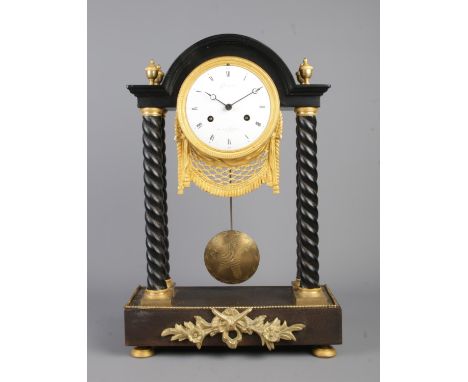 A 19th century French ebonised and gilt metal Portico clock. The dial stamped Champion, Rue de la Feuillade, Paris. Height 42