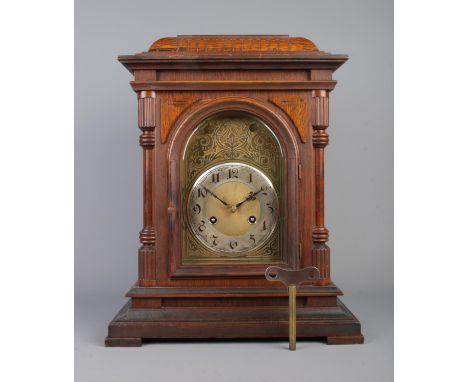 A carved mahogany Junghans eight day bracket clock. Westminster chiming with etched brass dial and Arabic numeral markers. Wi