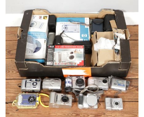 A box of various digital cameras, including examples from Fujifilm, Olympus, Halina and Rollei etc. Some boxed and in cases. 