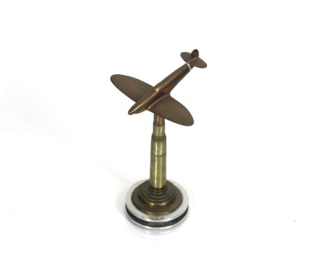 A "Trench Art" table lighter crafted from a .50 Cal. inert round, topped with a cast brass plane 