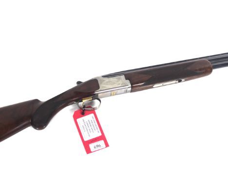 A 16 bore over and under shot gun by Browning, with 26" barrels. This fine shotgun is a White Lightening model in excellent o