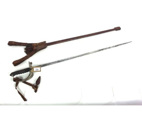 A Scotts Guards officers sword with scabbard and leather frog. This levee example has G.R.V cypher and battle honours on blad