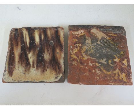 An English Medieval floor tile with inlaid design of a dragon, probably 14th/15th century together with a marble slip ware ti