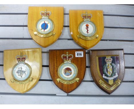 Four RAF wooden armorial wall plaques together with a Royal Army Medical Corp plaque - five pieces - good condition