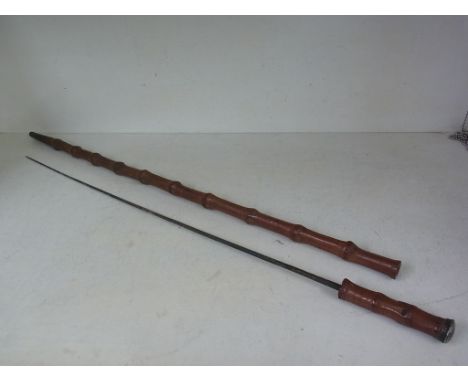 An early 1900s/late 1800s bamboo sword stick with gilt decorated blade - total length  90cm - pitted, missing its shoulder