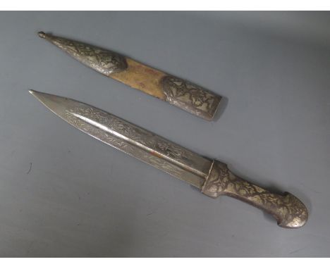 A Persian dagger with white metal handle and scabbard - blade length 27cm - blade having white metal inlay, general condition