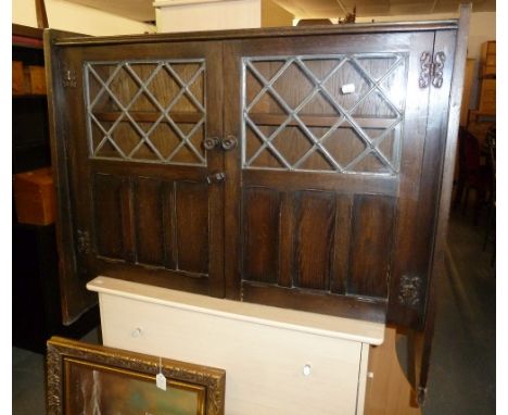 AN OAK DWARF BOOKCASE ENCLOSED BY TWO LEAD LIGHT DOORS, 3'4" WIDE